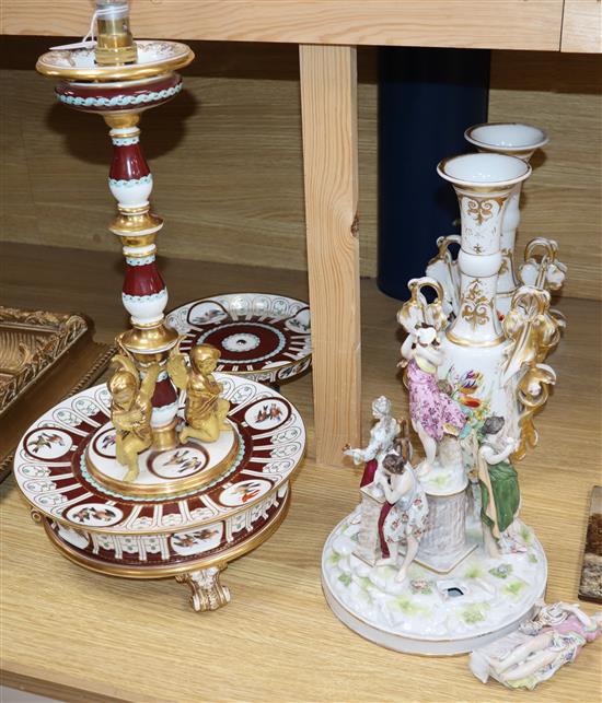 A French ceramic lamp, decorated with German figurines representing the arts, a matching tazza, a figure and pair of vases tallest 44cm